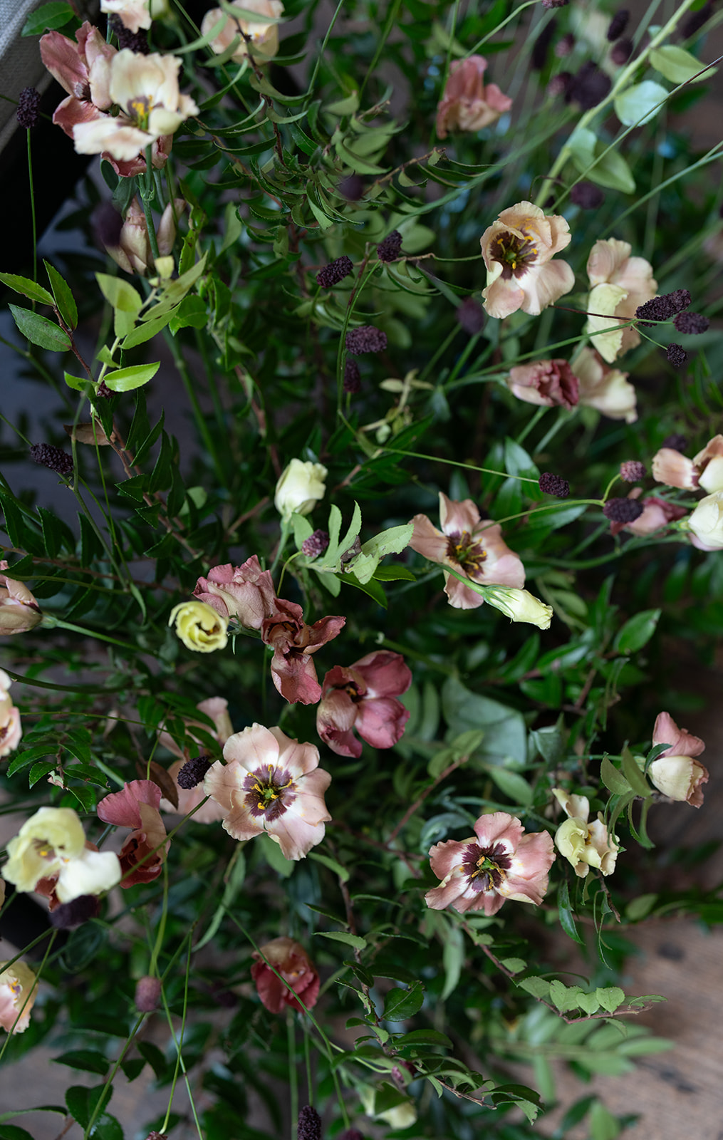 Layered green foliage and white flowers in the reception design