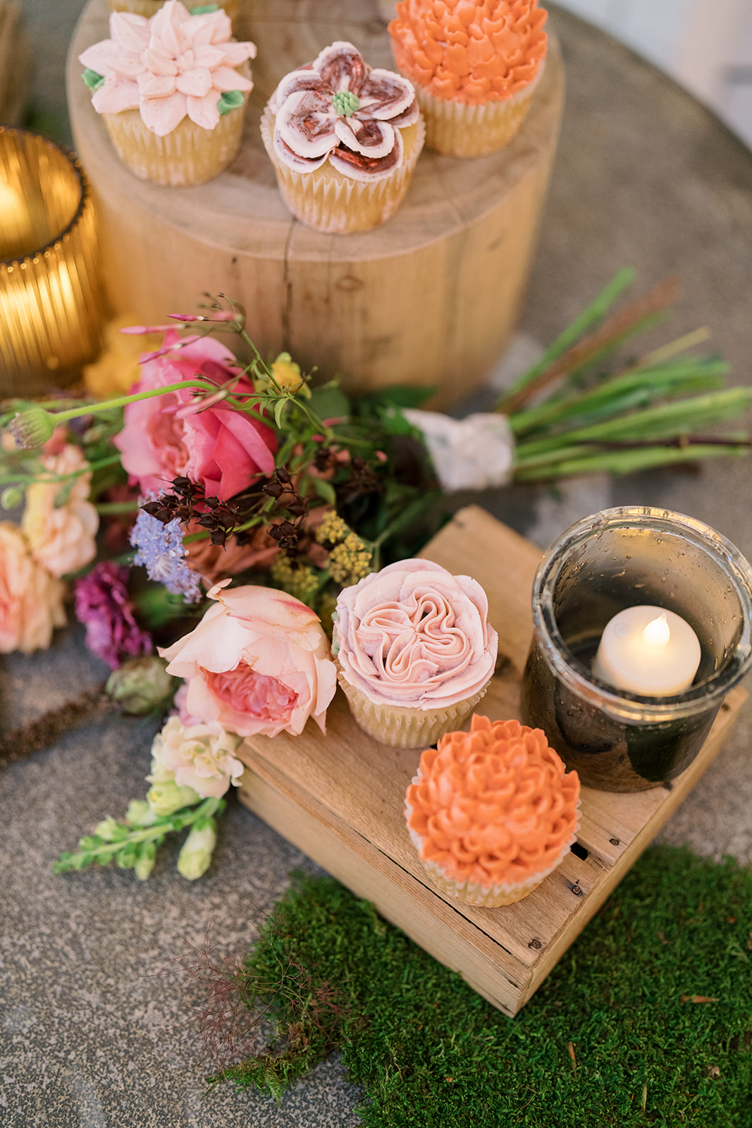 Small wedding desserts displayed with flowers and candlelight