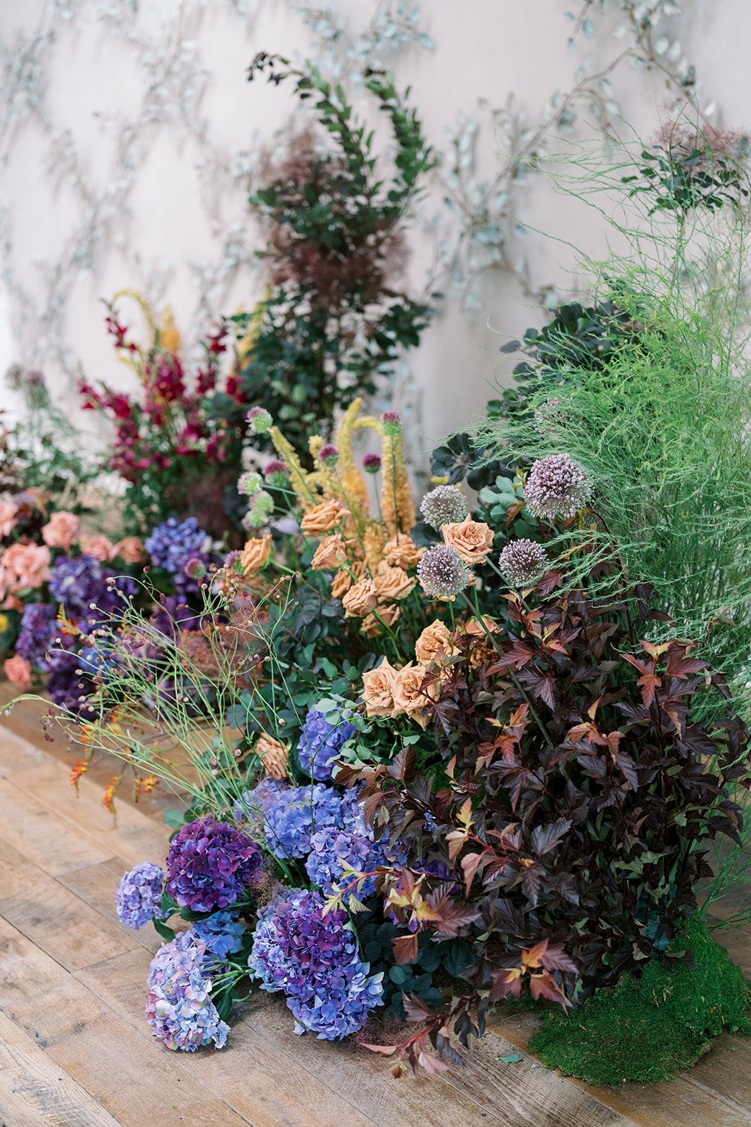 Large ceremony floral installation with hydrangeas and garden flowers