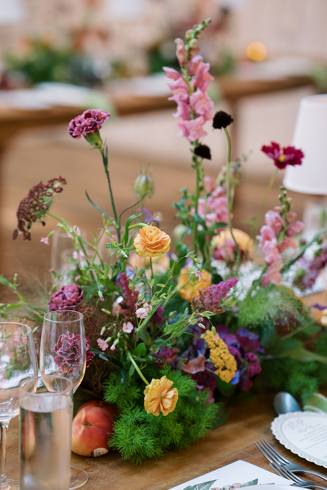 Loose garden flowers arranged along a reception table