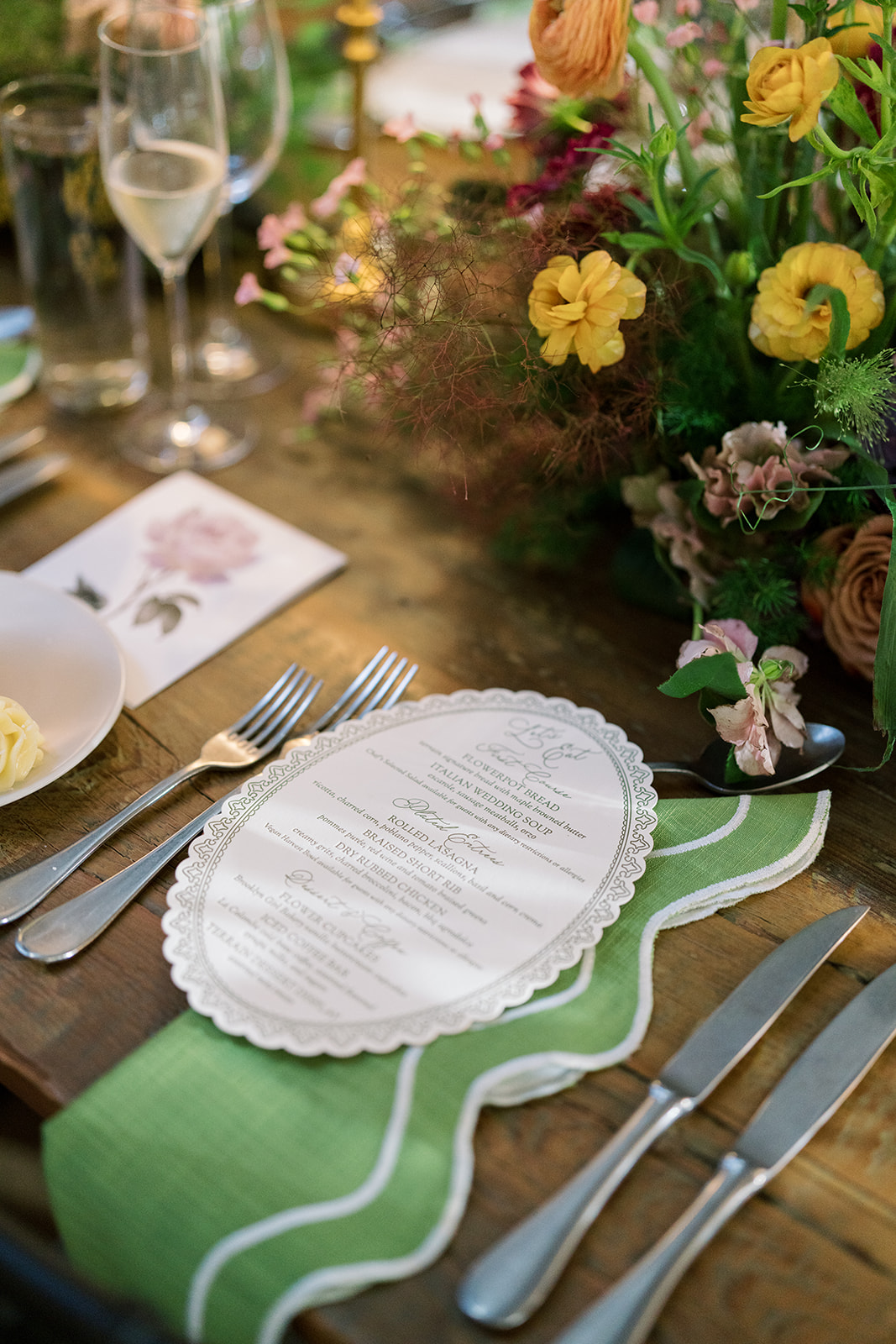 Place setting with menu and green wavy-edge charger