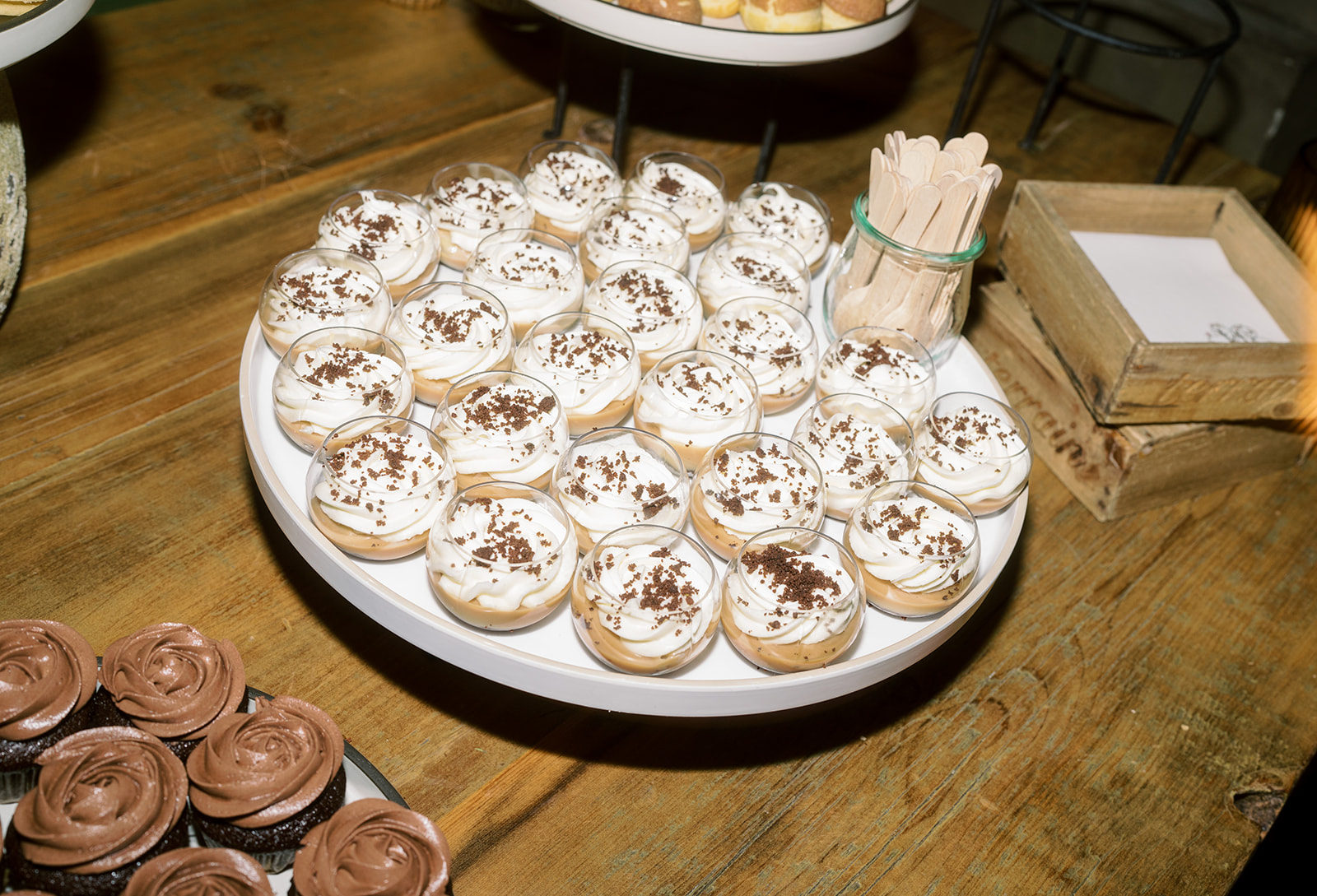 White frosted cupcakes arranged for guests