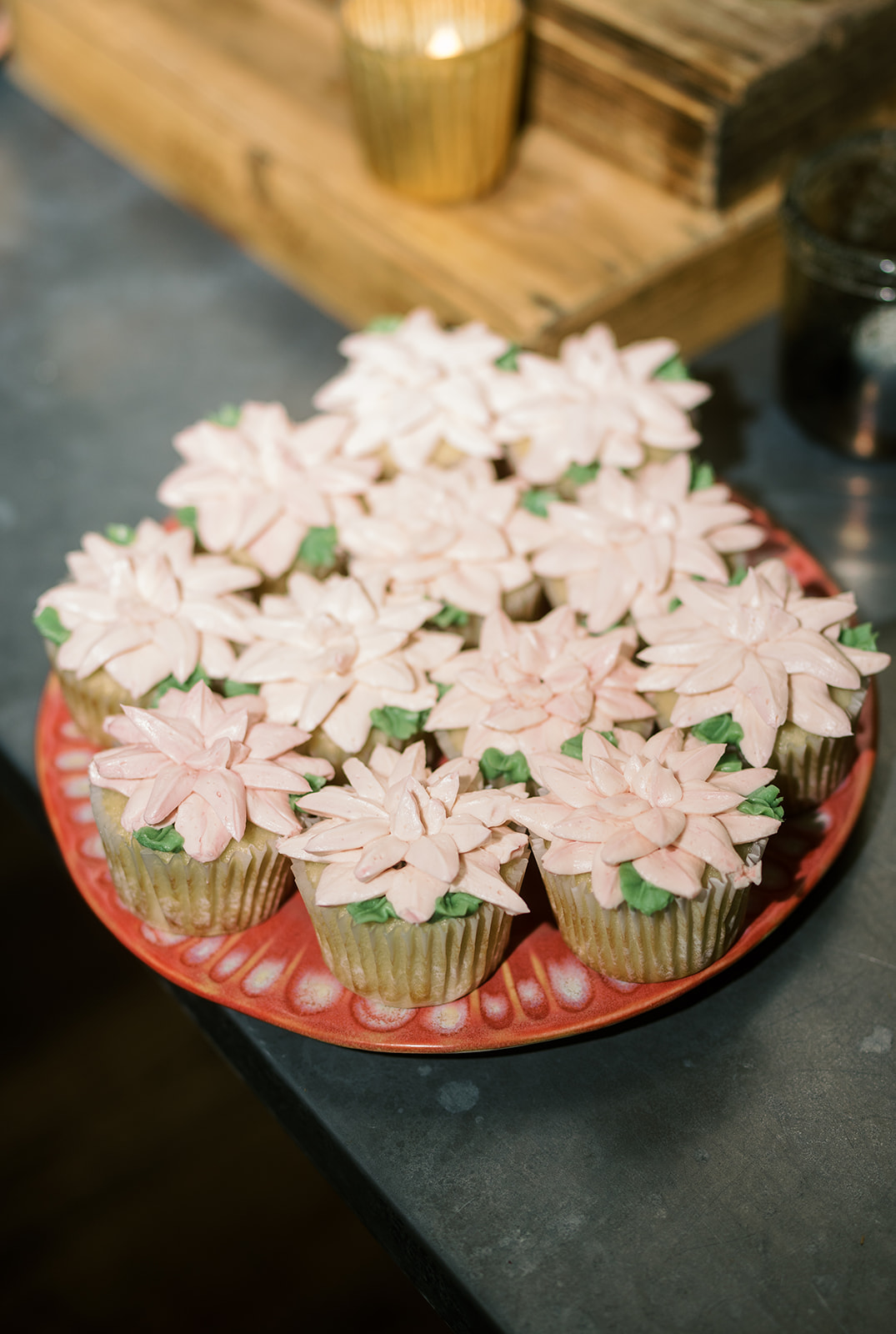 White frosted cupcakes arranged on a red serving plate