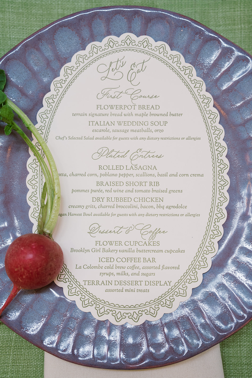 Dinner menu displayed on an iridescent plate with a red fruit accent