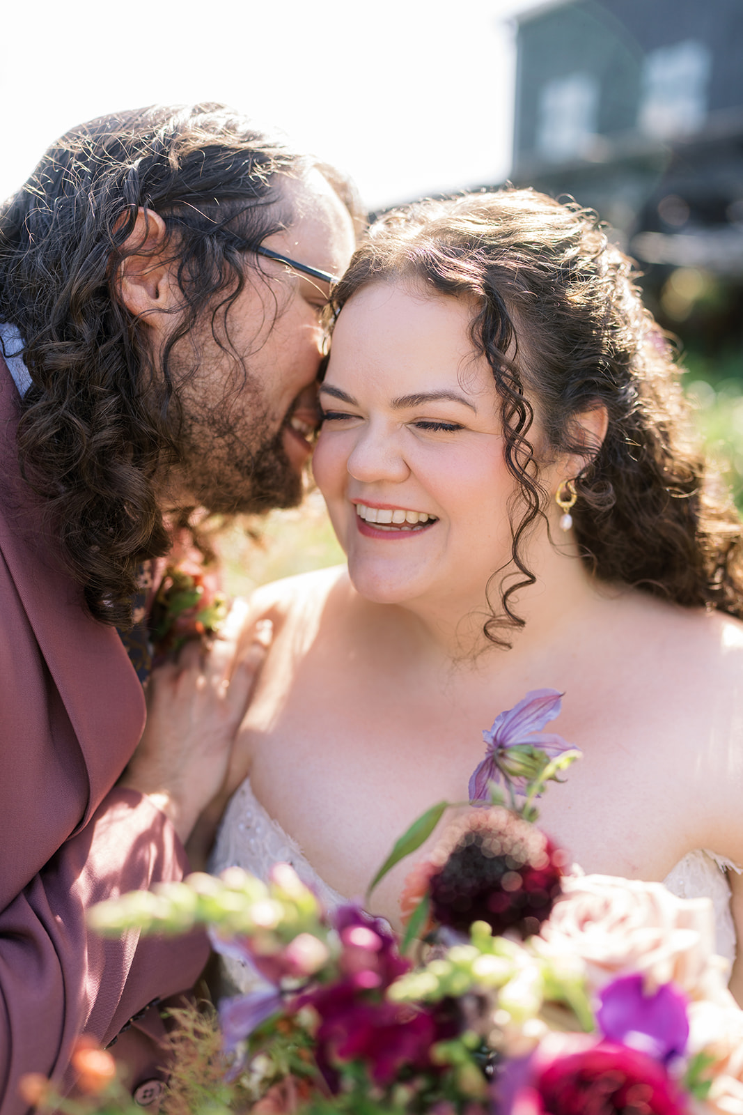 Jeff kissing Breanna on the cheek during a close wedding-day portrait