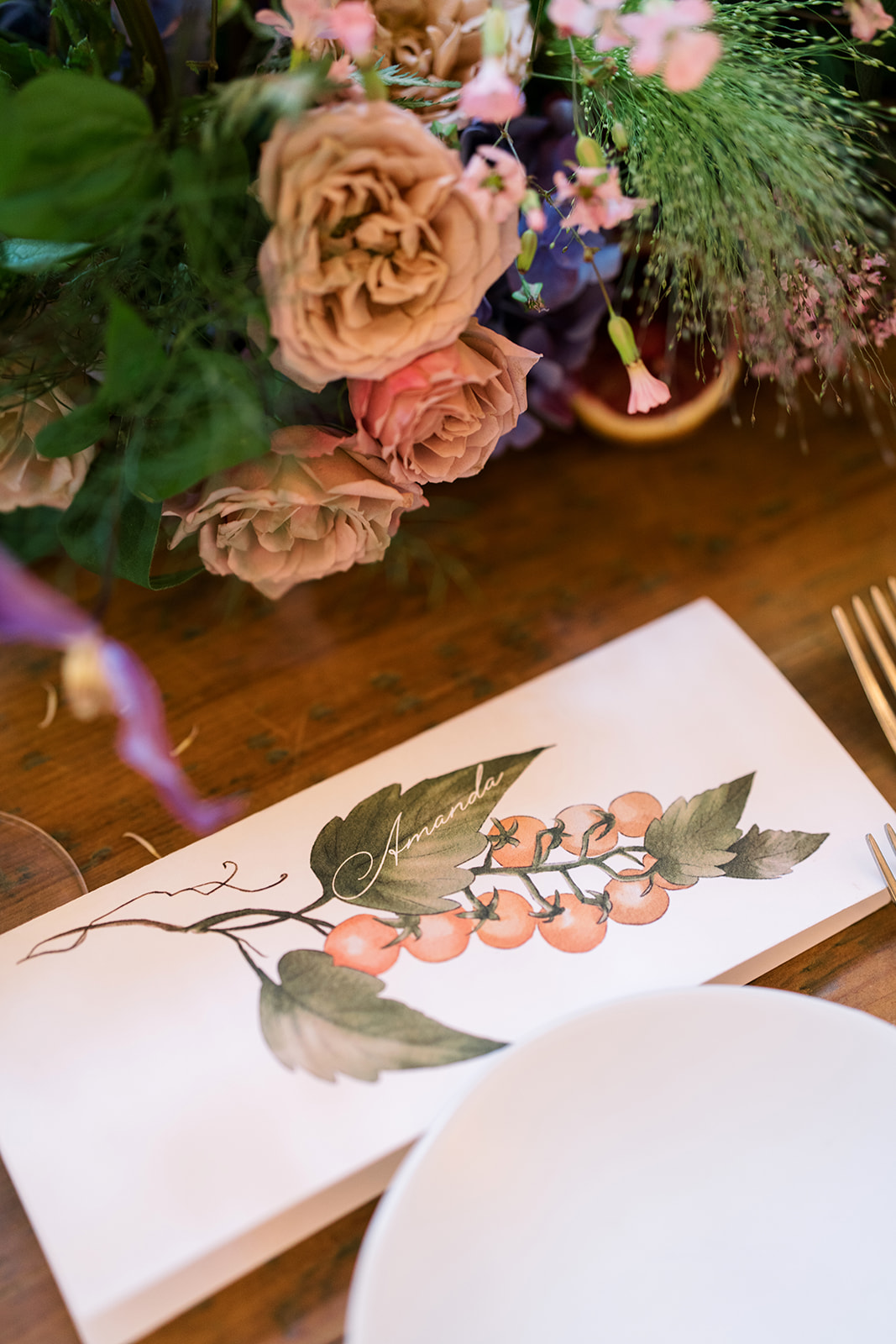 Botanical place card and plate detail at the reception table