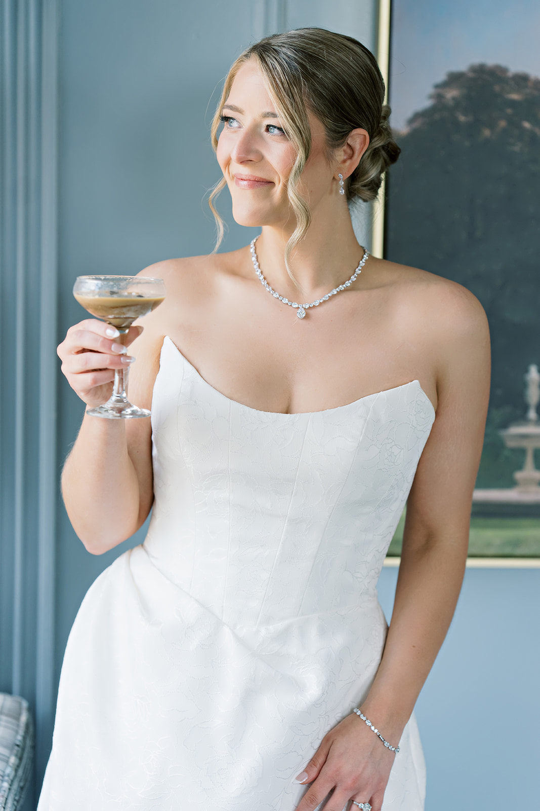 Caroline holding a cocktail in a bridal portrait at The Lytle Park Hotel