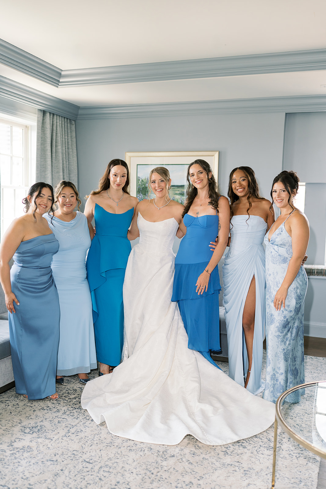 Caroline with bridesmaids in shades of blue before the ceremony