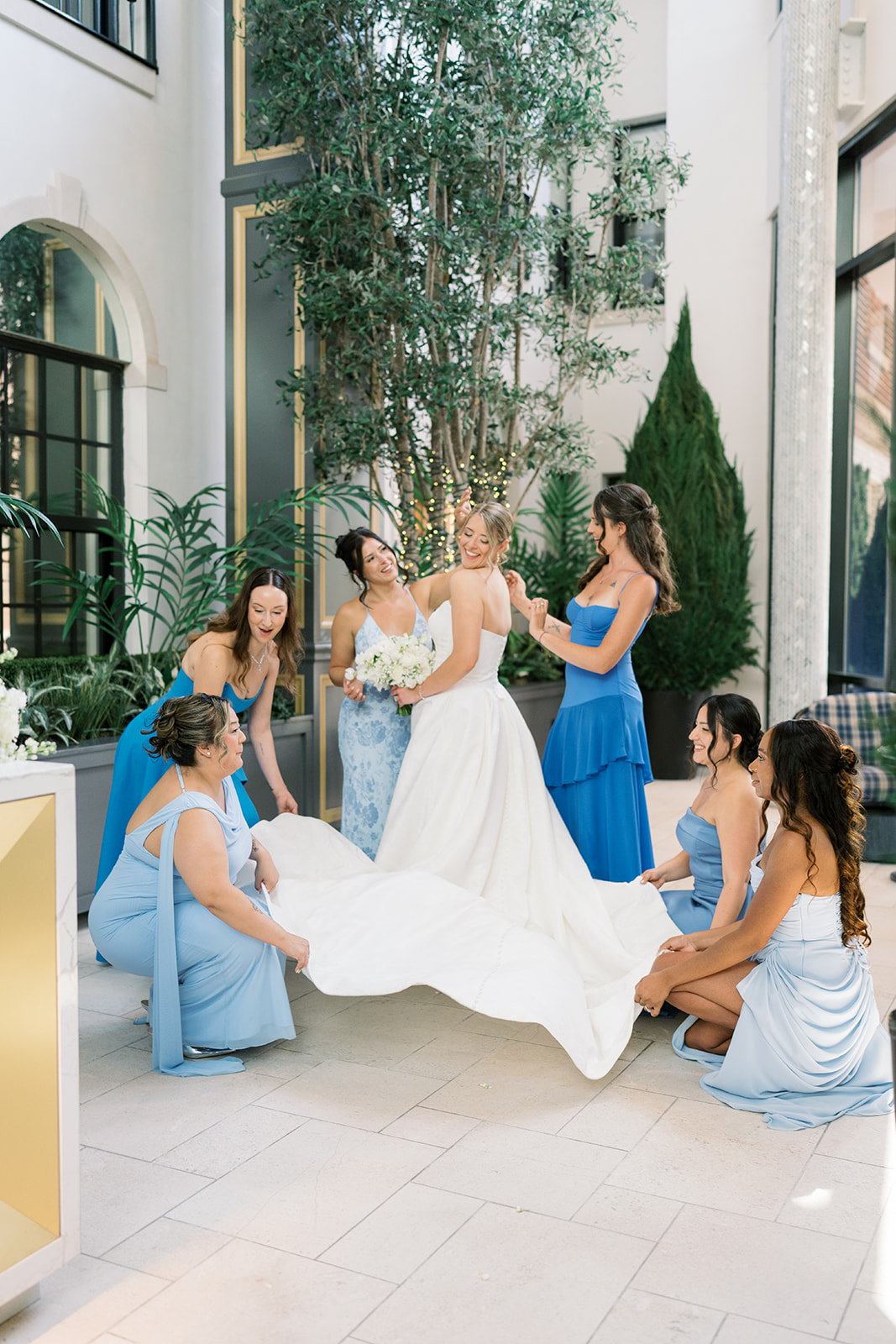 Caroline laughing with her bridesmaids before the rooftop ceremony