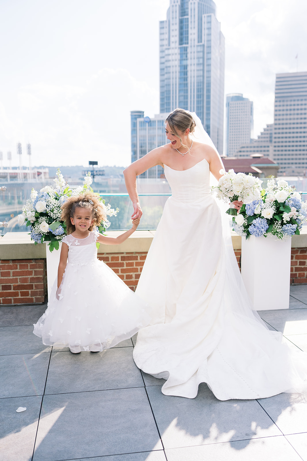 Caroline with a flower girl on the rooftop at Vista at Lytle Park
