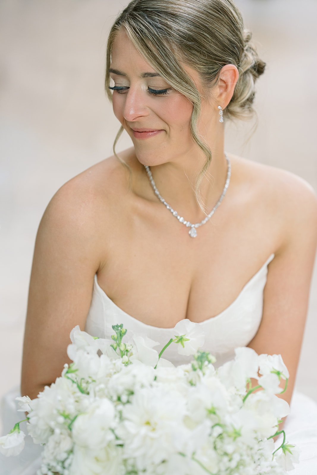Caroline holding a white bridal bouquet in a portrait at The Lytle Park Hotel
