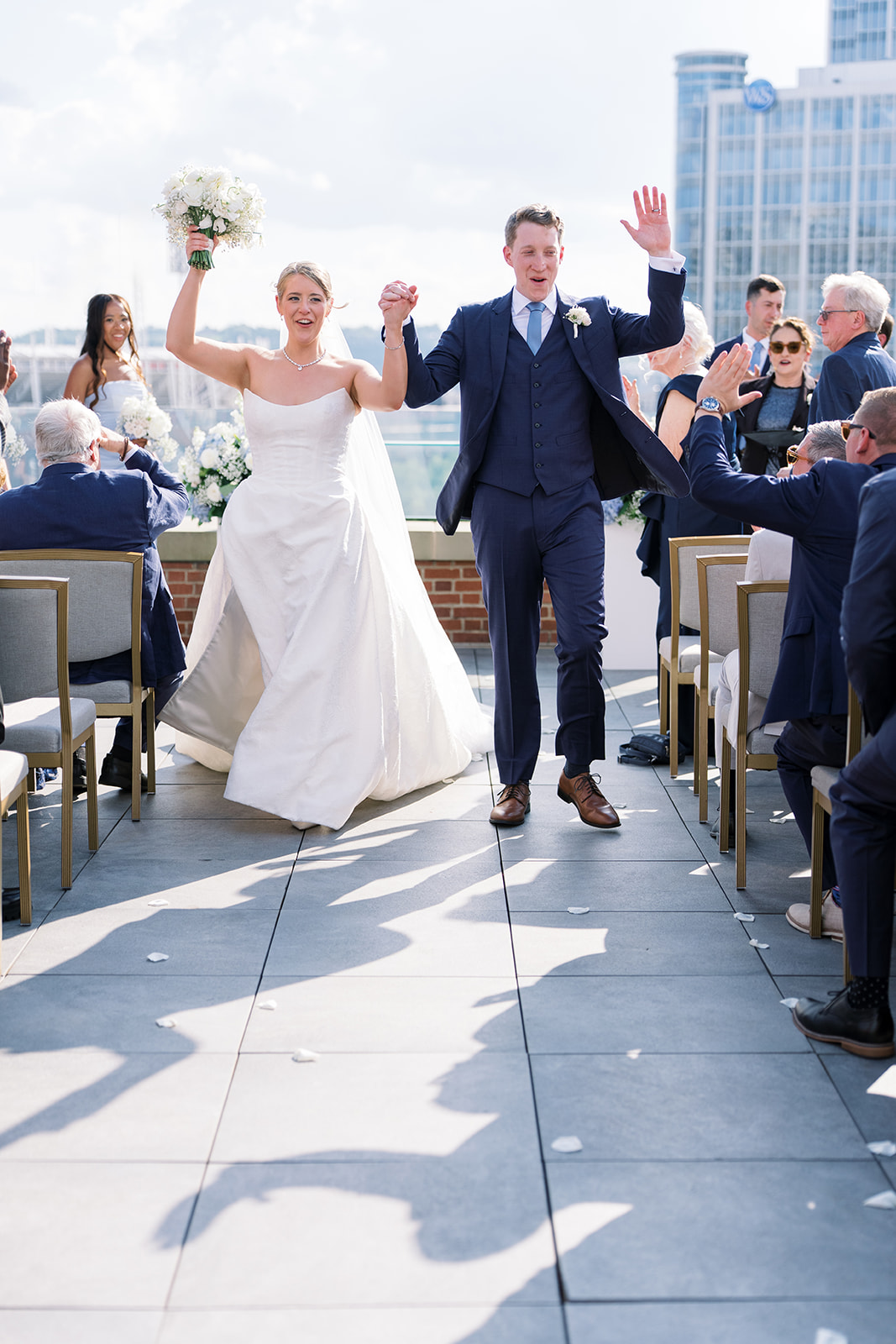 Joey and Caroline walking back down the aisle after their rooftop ceremony