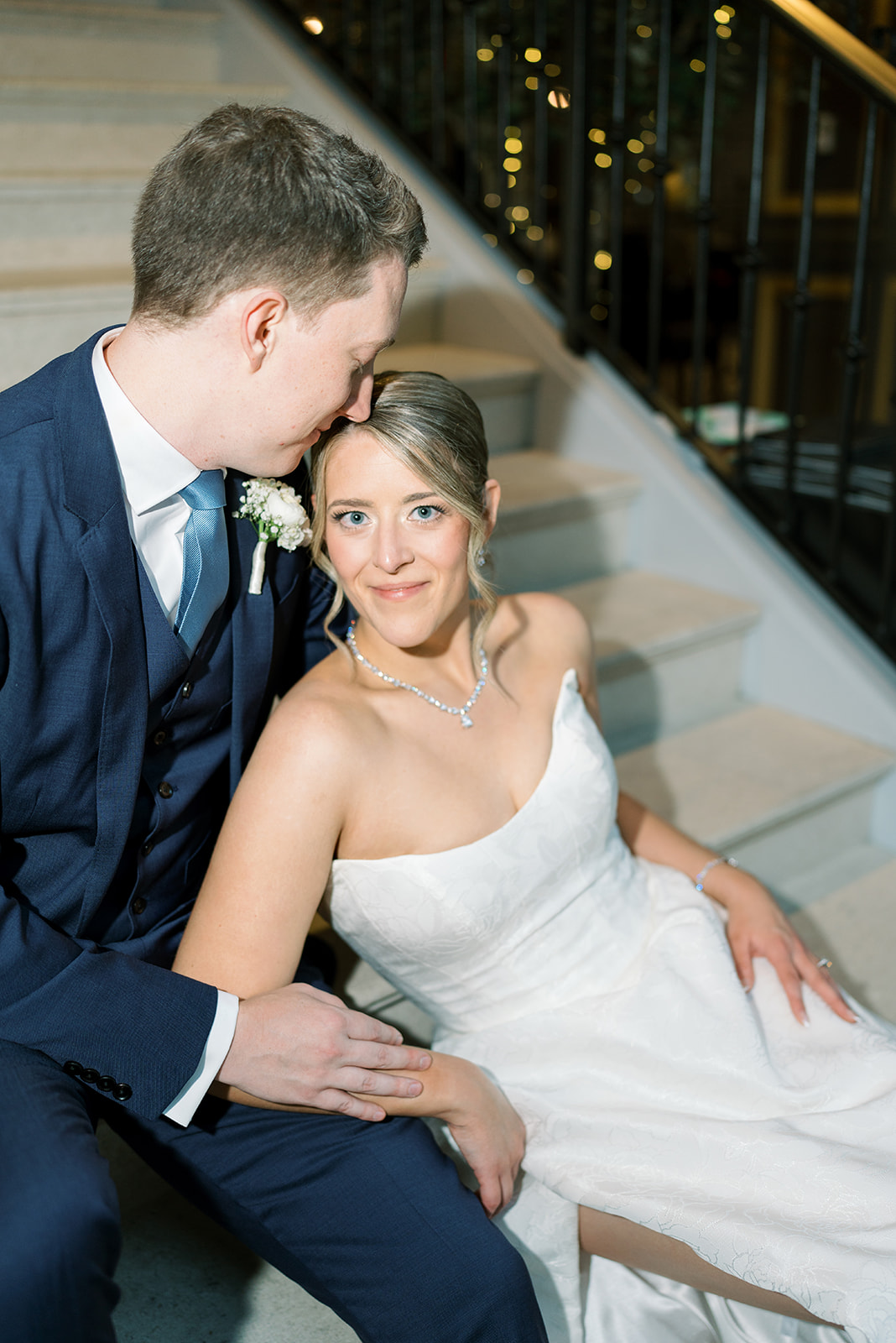 Joey and Caroline seated closely together for a wedding portrait