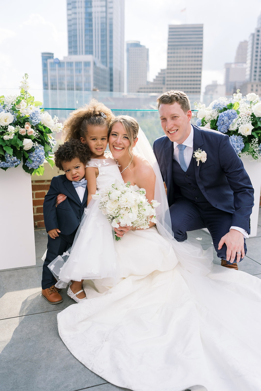 Joey and Caroline with family after the rooftop wedding ceremony