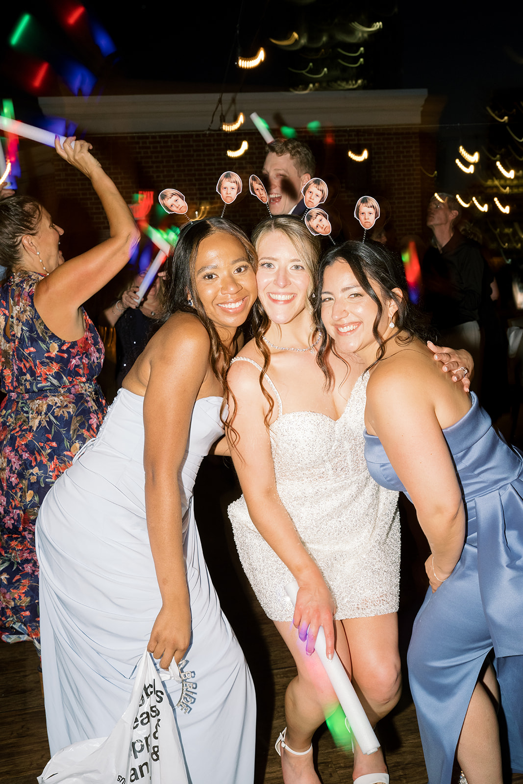 Wedding guests celebrating on the dance floor late in Joey and Caroline's reception