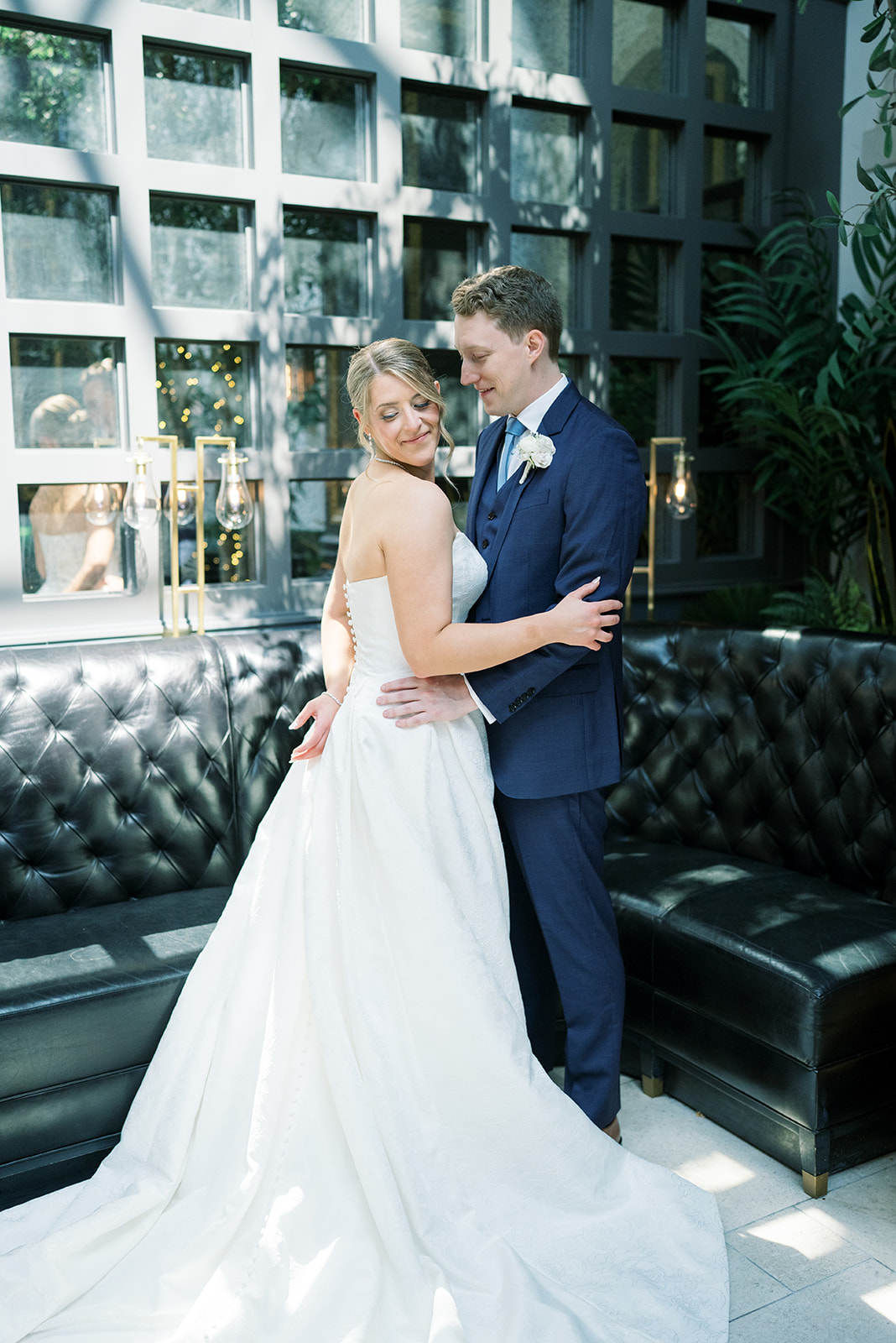 Joey and Caroline embracing in a lounge at The Lytle Park Hotel