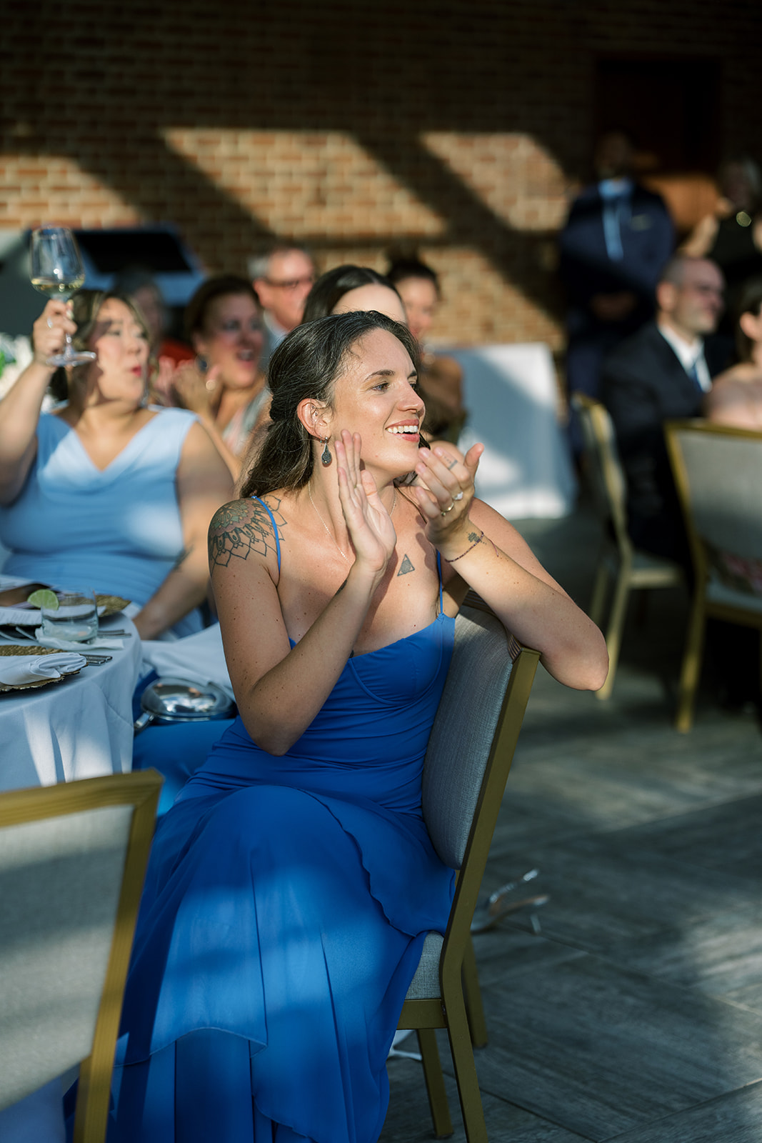 A guest reacting during speeches at Joey and Caroline's wedding reception