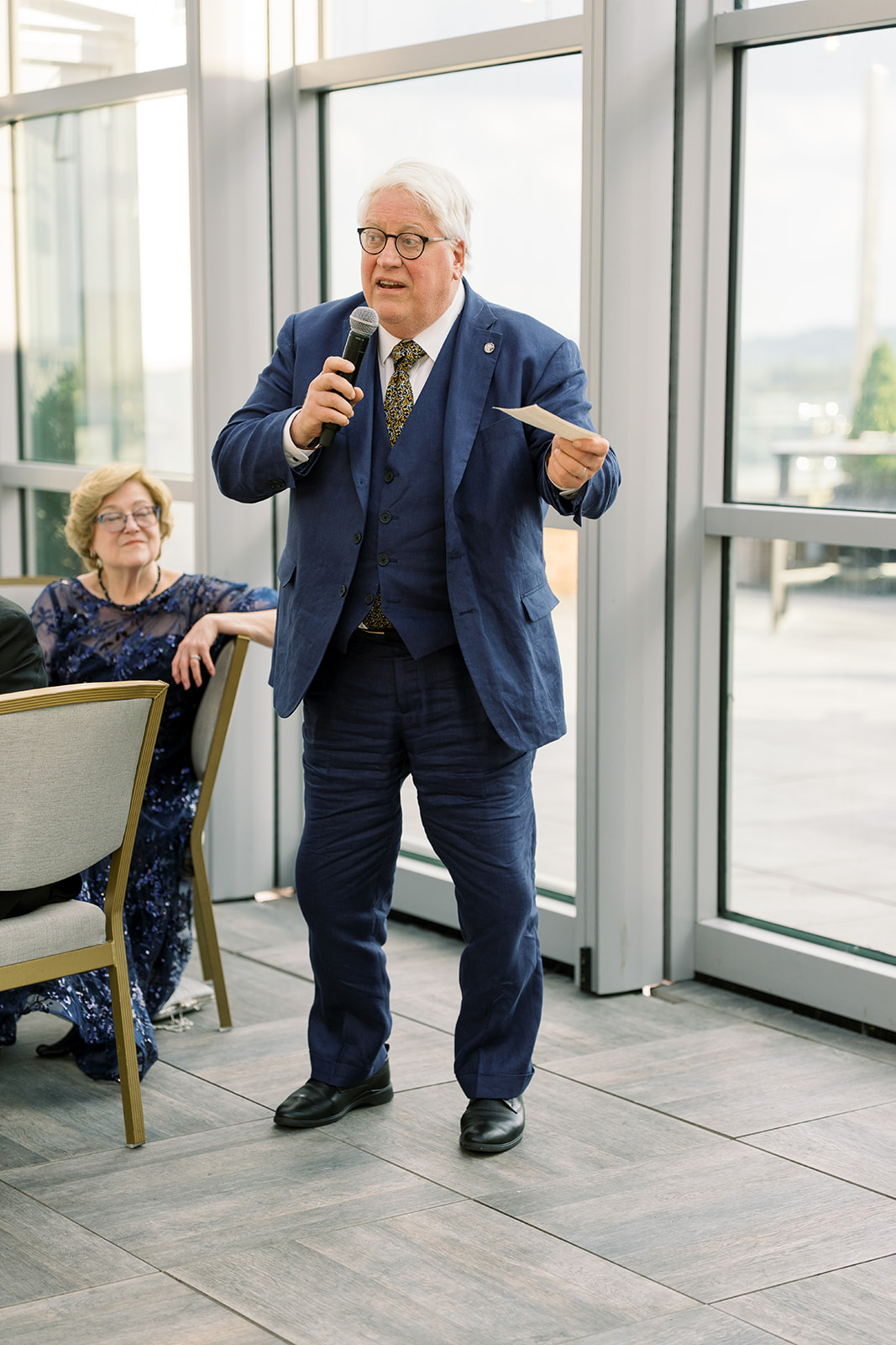 A guest giving a speech during Joey and Caroline's wedding reception