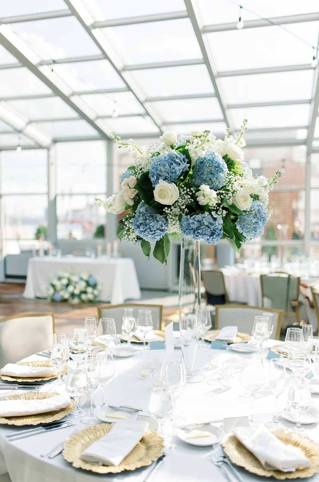 Wedding reception table with blue and white flowers at Vista at Lytle Park