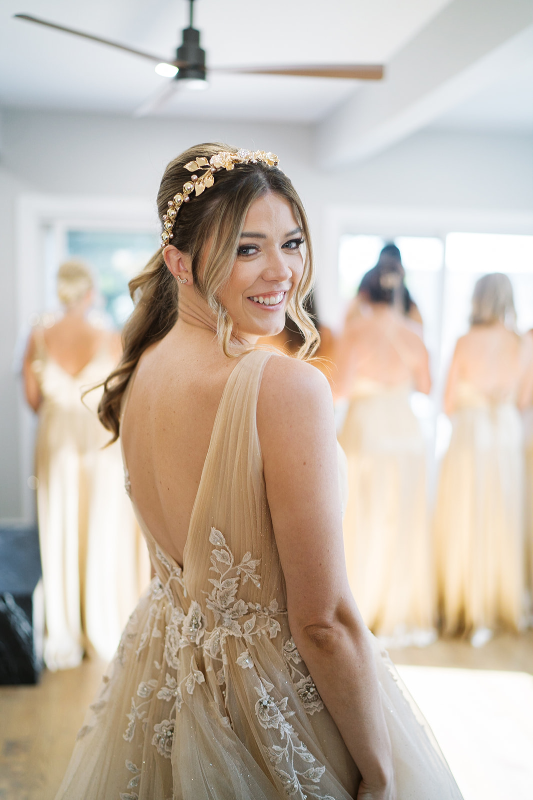 Courtney showing the detailed back and warm champagne tone of her wedding gown