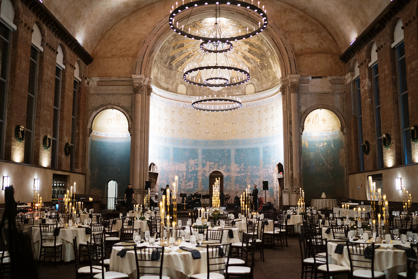The candlelit reception room at The Monastery Event Center