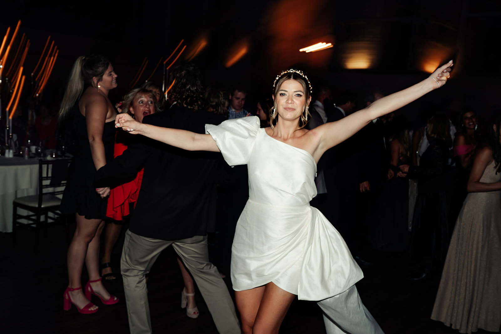 Courtney on the dance floor in her short white off-the-shoulder reception dress
