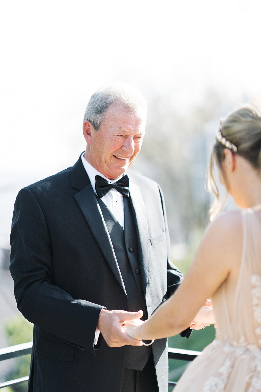 Courtney and her dad Greg holding hands after their first-look moment