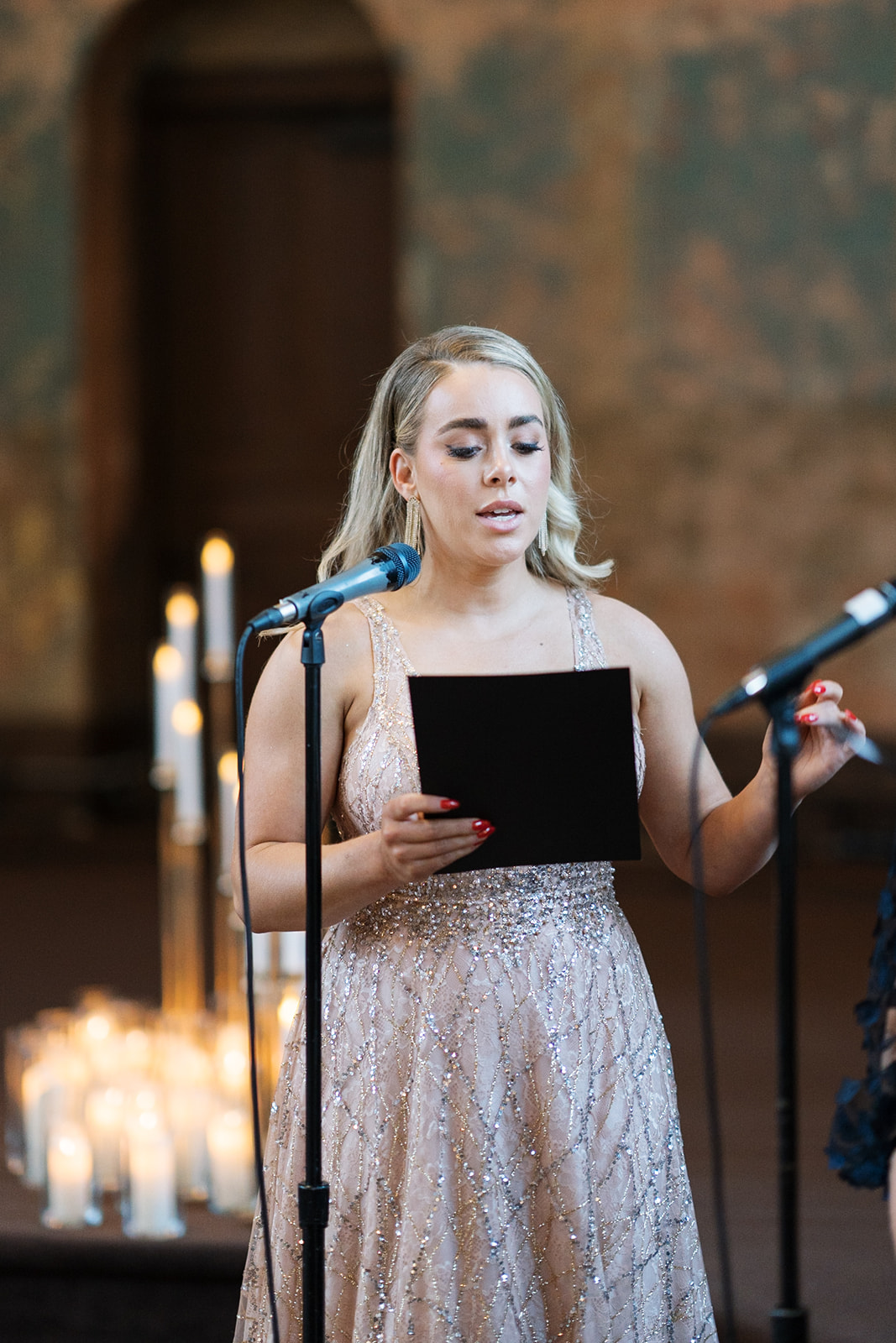 A singer performing during Kyle and Courtney's ceremony at The Monastery Event Center