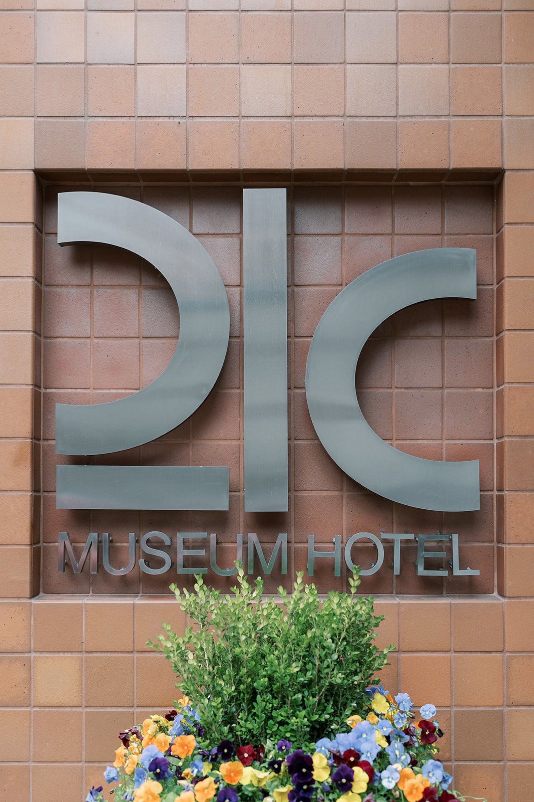 21c Museum Hotel Cincinnati exterior sign photographed during Meghan and Kevin's wedding-day preparations