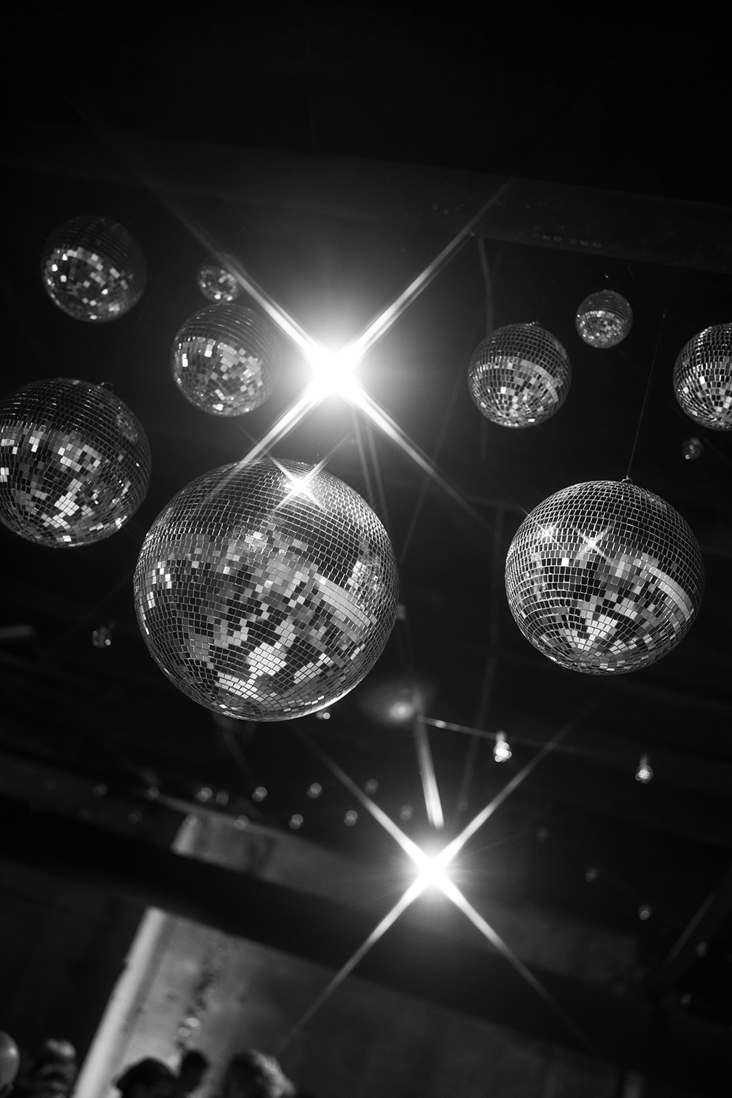 Black-and-white view of disco balls and reception lights