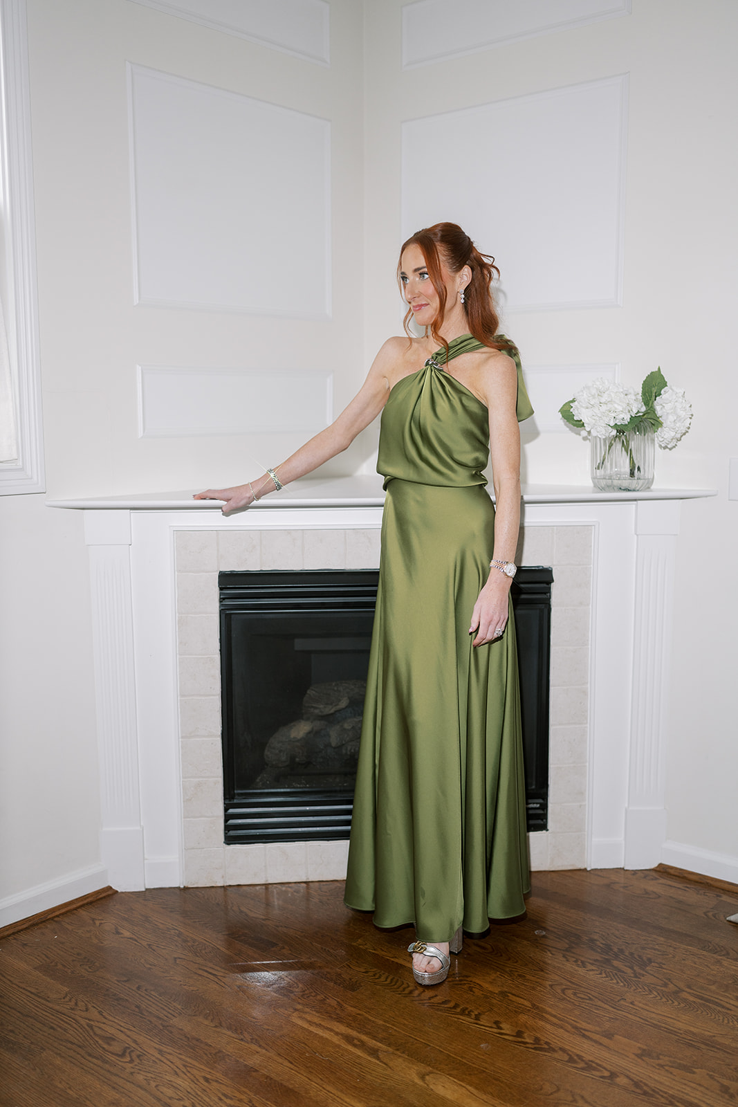 Portrait of a woman in a green satin dress during wedding-day preparations
