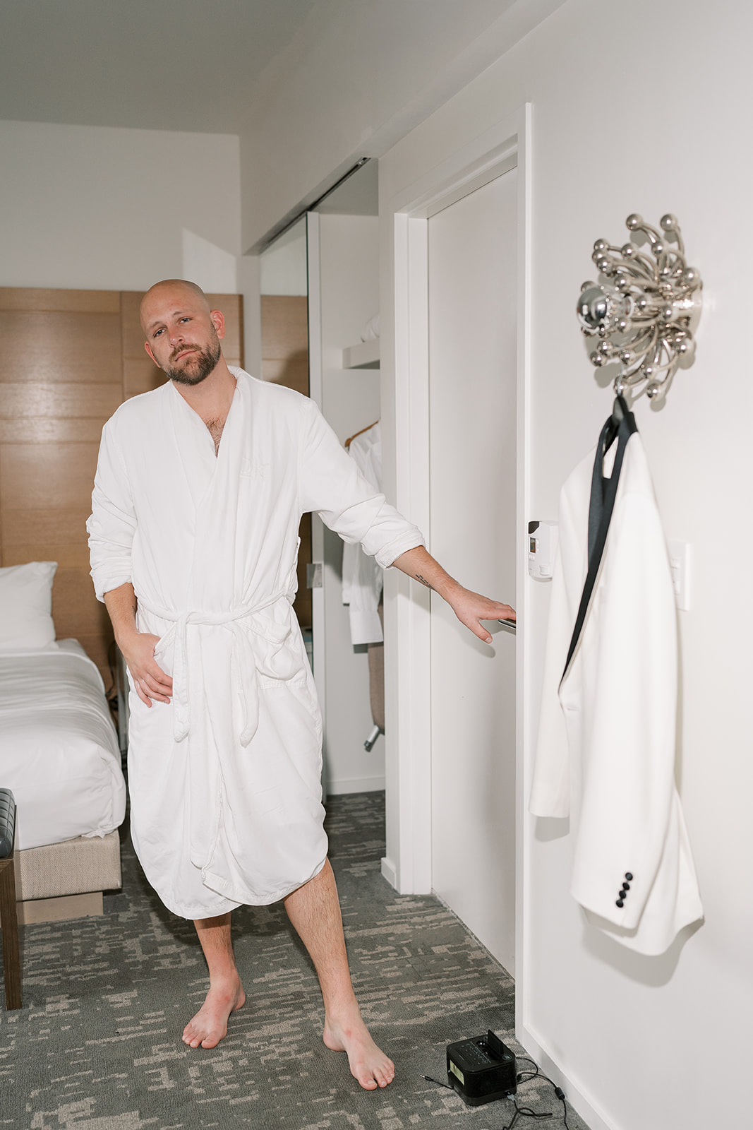 Kevin getting ready beside his white dinner jacket before the wedding