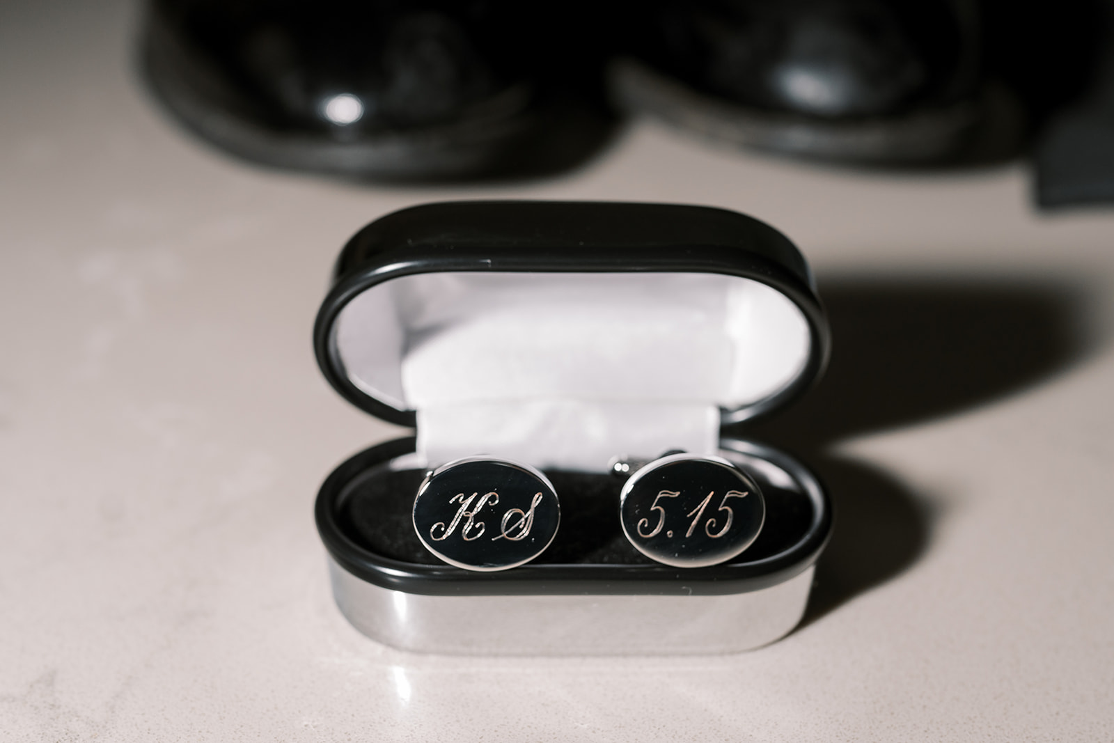 Personalized cufflinks photographed among Kevin's wedding-day details