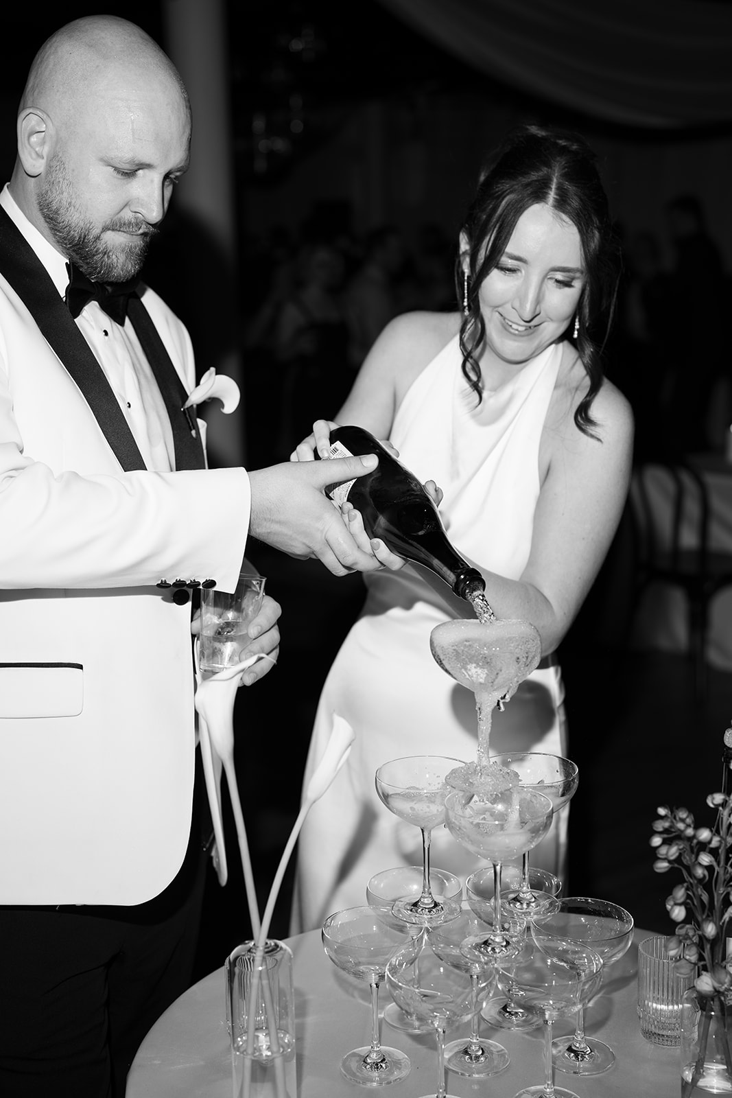 Meghan and Kevin together beside the champagne tower during the reception