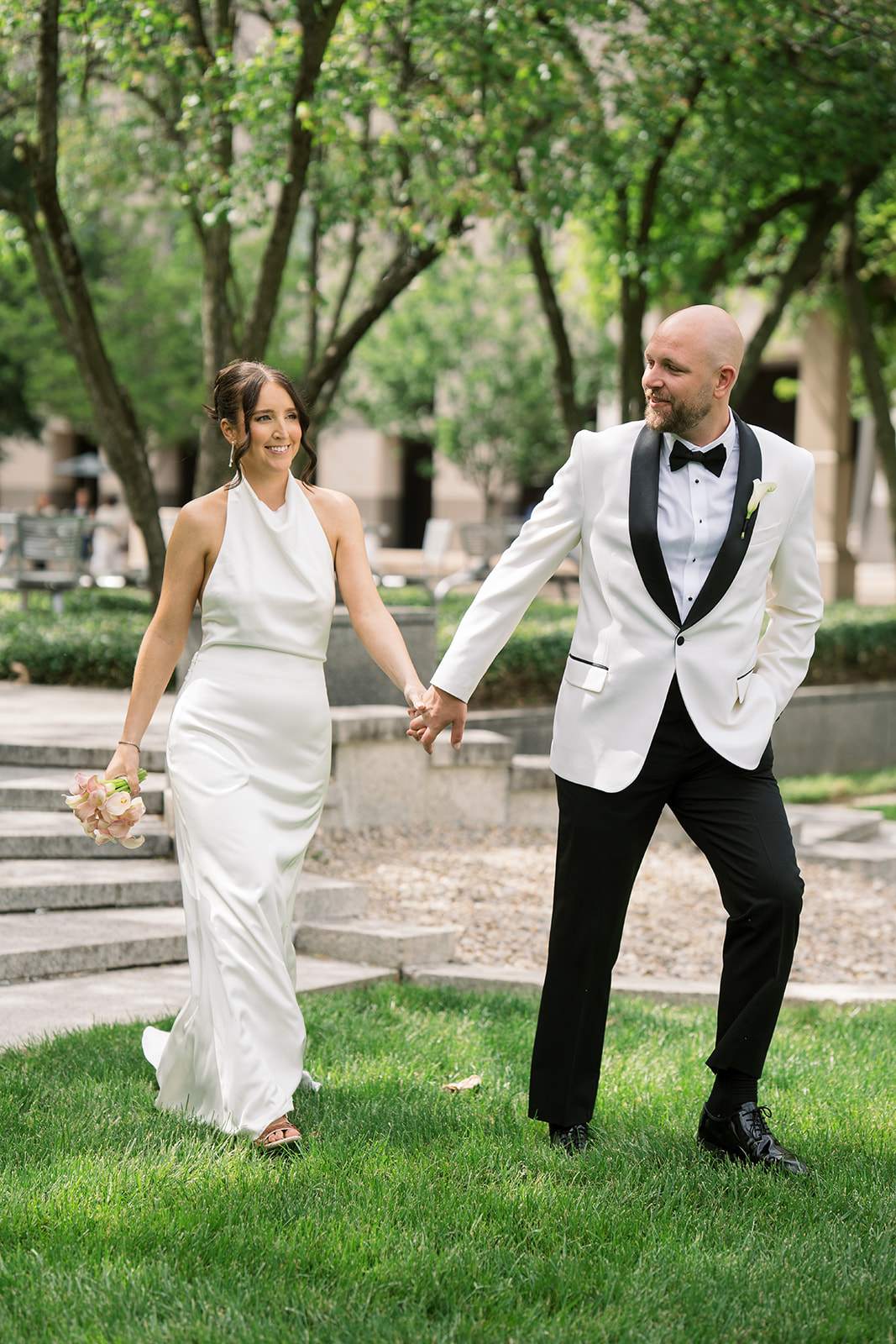 Meghan and Kevin laughing together during portraits in downtown Cincinnati