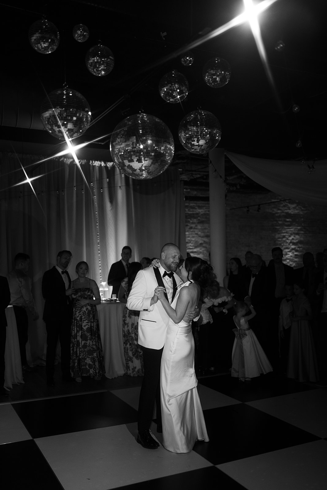 Black-and-white photograph of Meghan and Kevin dancing together during their reception