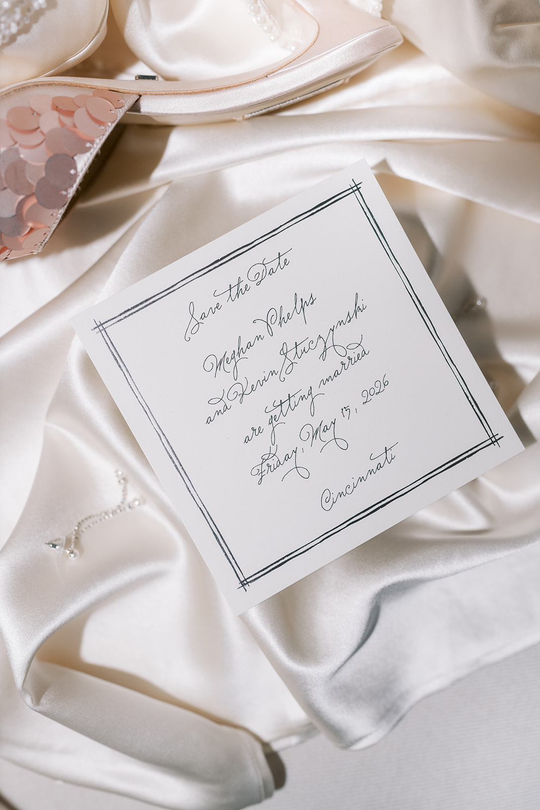 Handwritten wedding-day note arranged with bridal details on ivory satin