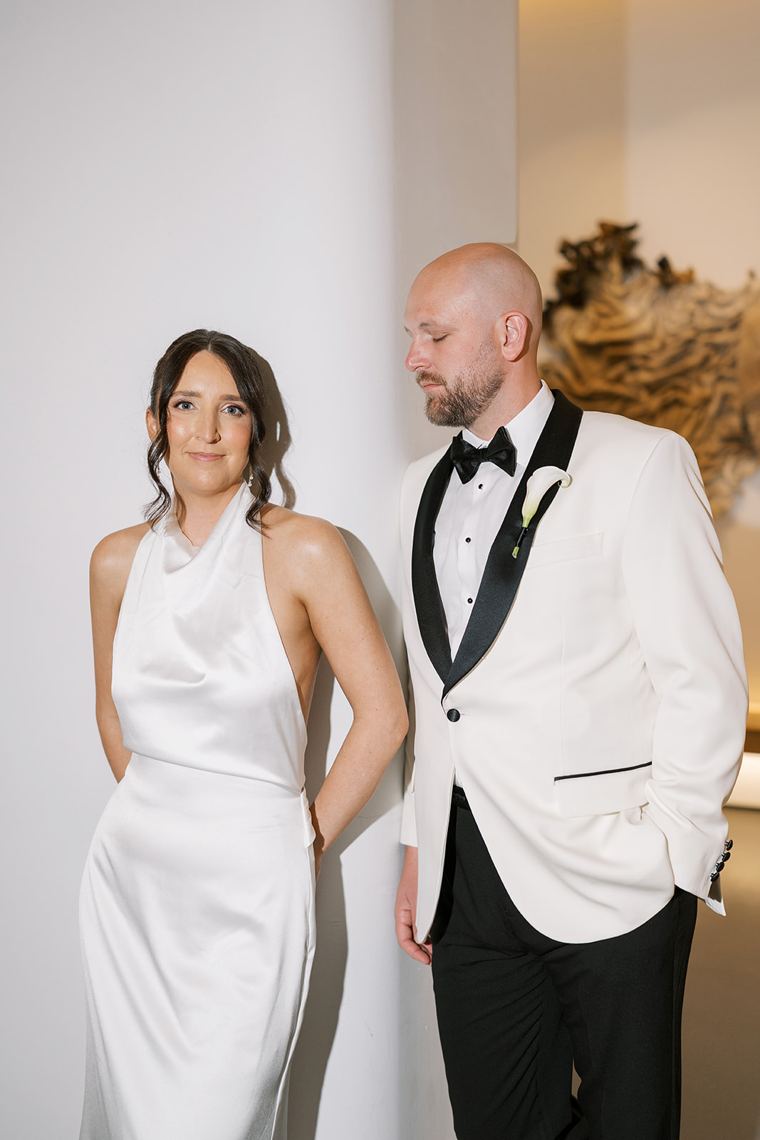 Meghan and Kevin posing together in front of contemporary artwork