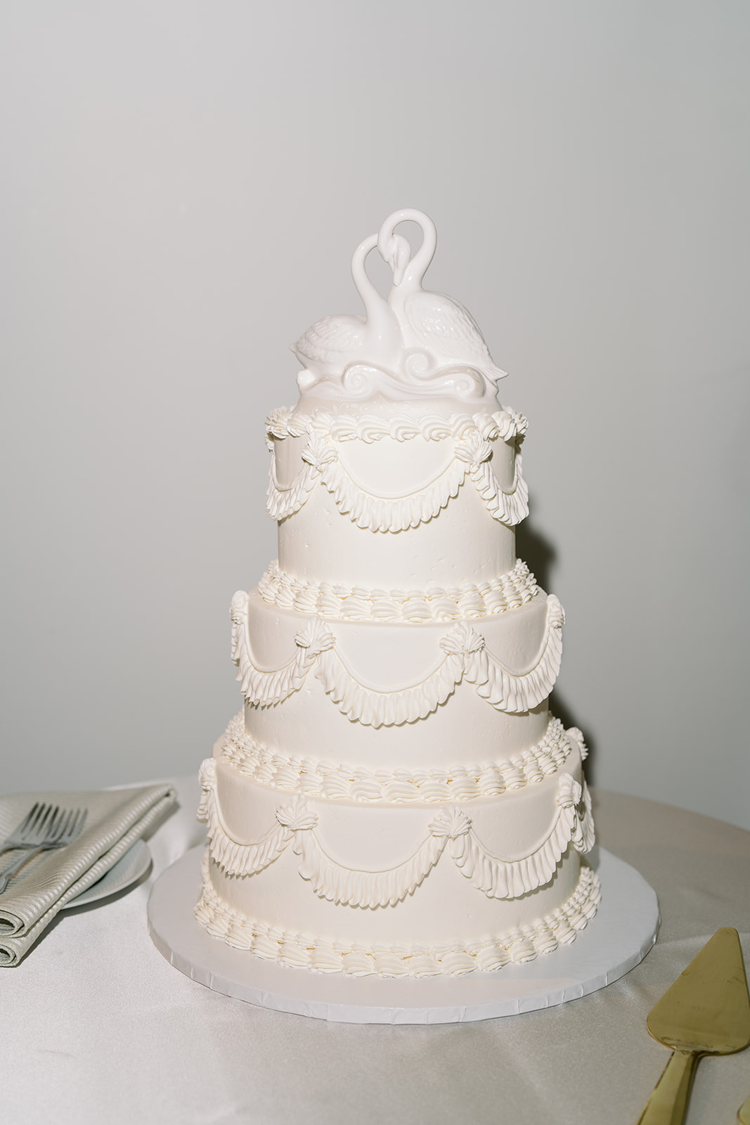 White tiered wedding cake with piped scallop details
