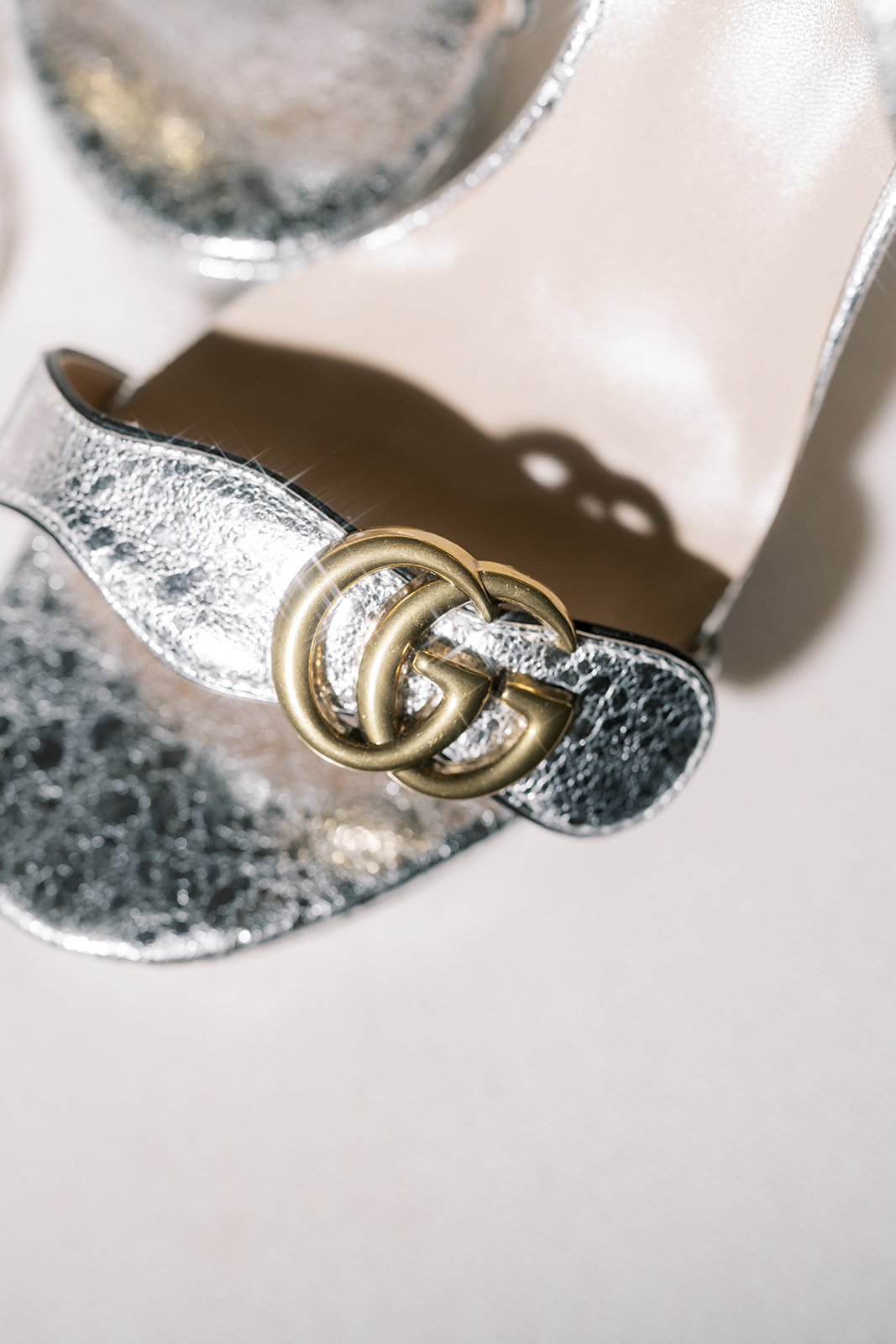 Metallic designer accessory photographed among Meghan's bridal details