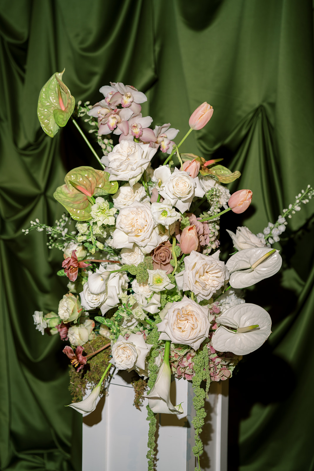 Pink orchids, pale roses and greenery in Meghan and Kevin's wedding floral design