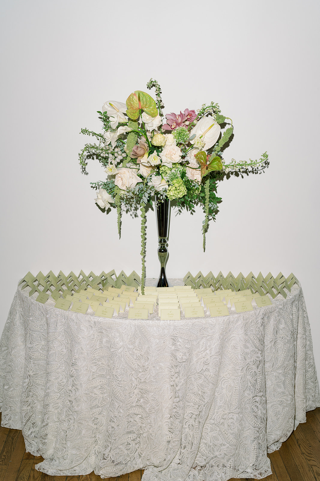 Pink, white and green wedding flowers arranged as a tall centerpiece