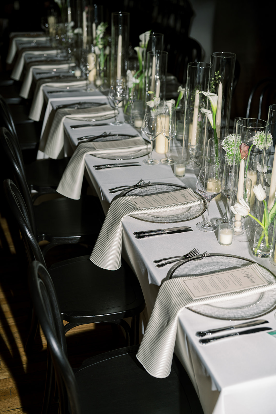 Long reception table set with glassware, candles and flowers at The Spot on West Fifth