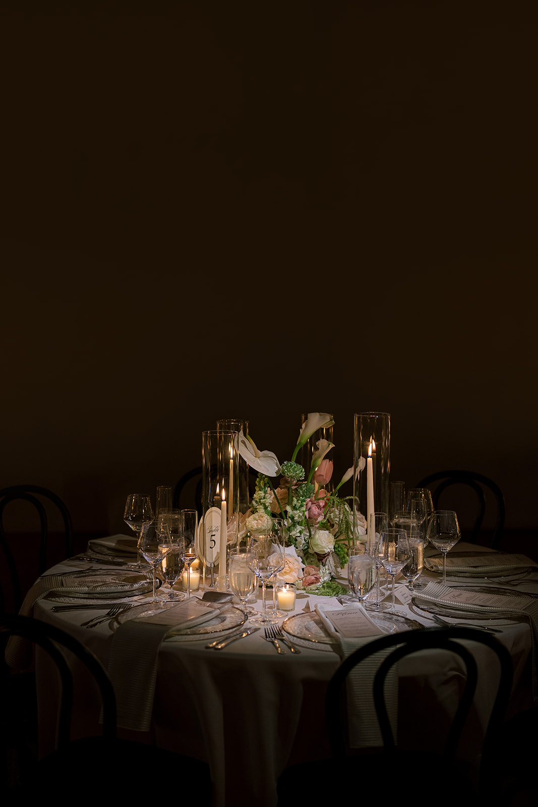 Reception table isolated in warm candlelight inside The Spot on West Fifth