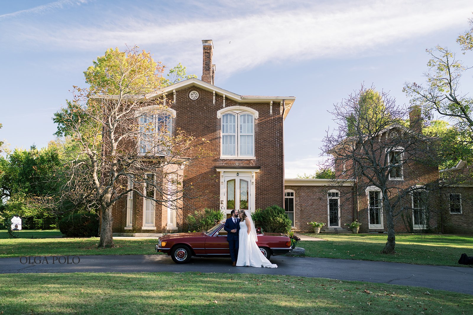 Historic Heartland of Versailles house with the vintage red Mercedes parked outside
