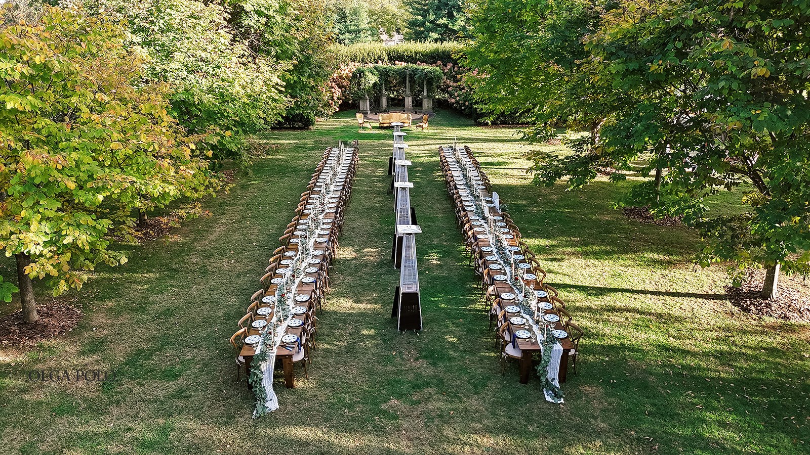 Aerial view of the outdoor wedding dinner arranged across the lawn at Heartland of Versailles