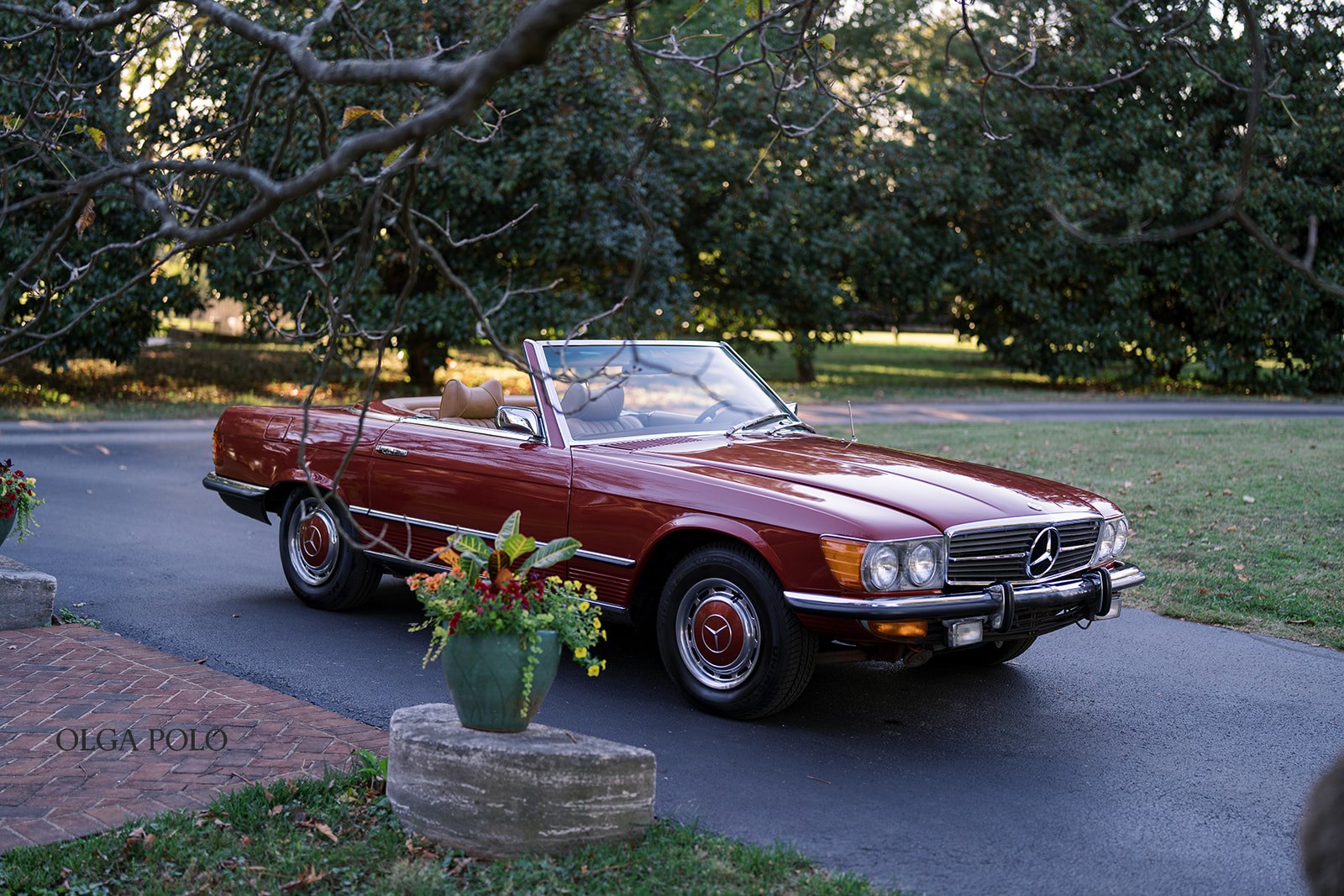 Vintage red Mercedes parked outside the historic house at Heartland of Versailles