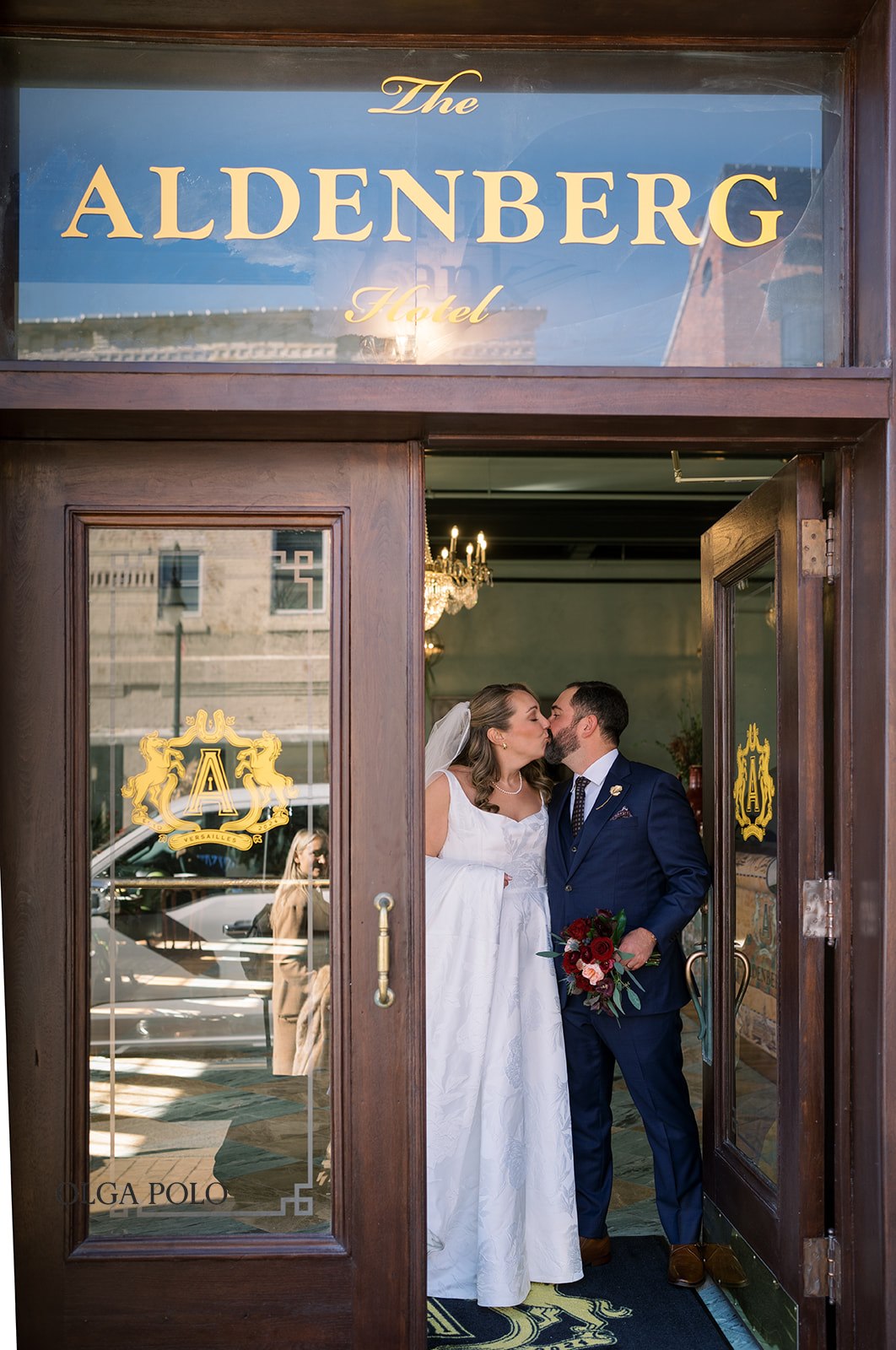 Ryan and Beth standing together at the entrance of The Aldenberg Hotel