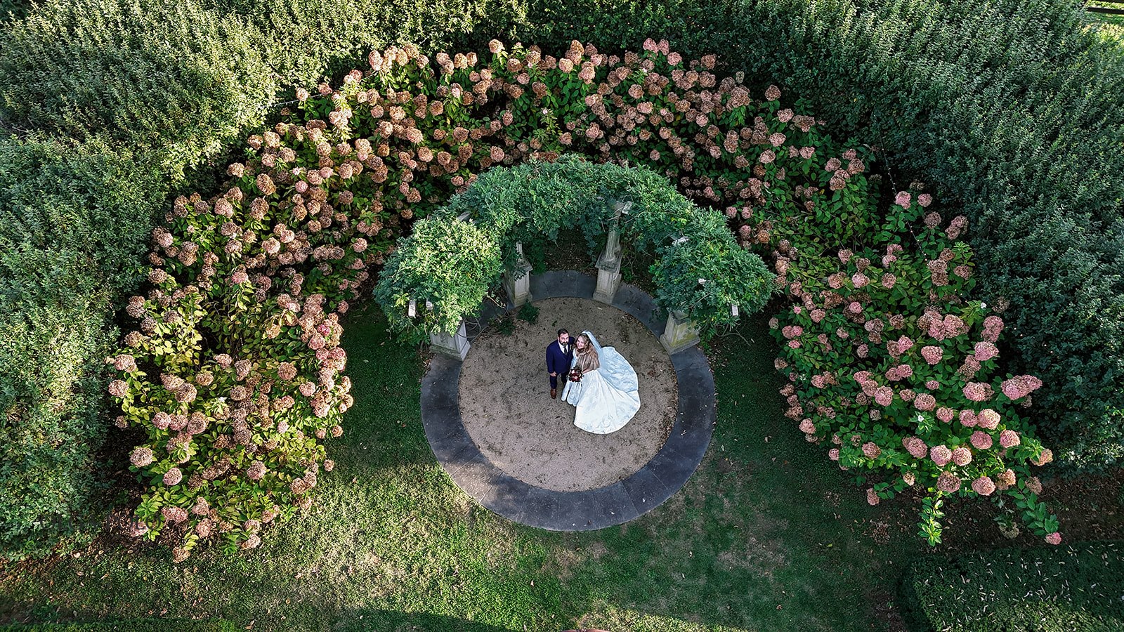 Overhead portrait of Ryan and Beth together in the garden at Heartland of Versailles