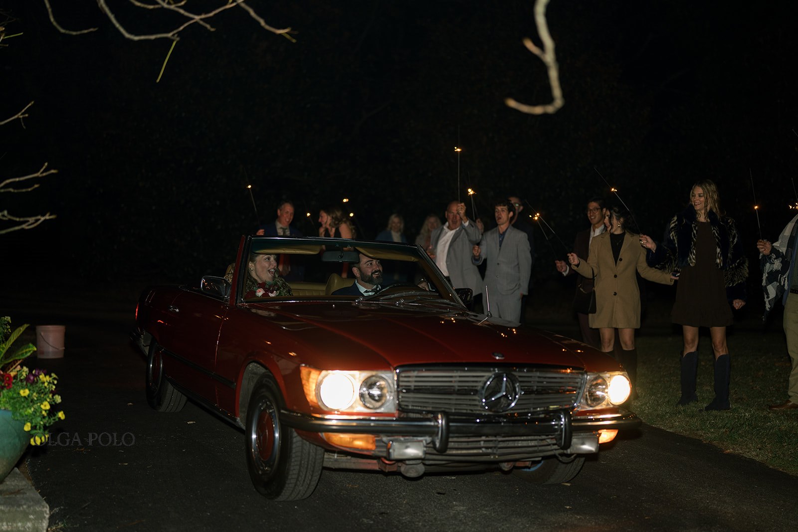 Ryan and Beth leaving their wedding celebration in the vintage red Mercedes